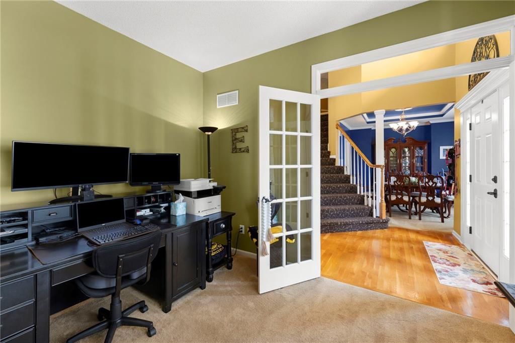 Main-floor primary bedroom and walk-in closet at 22007 52nd Street, Shawnee, KS 66226