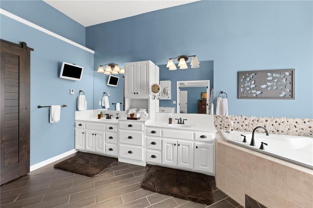 Tile floors, walk-in shower and freestanding tub at 22007 52nd Street, Shawnee, KS 66226