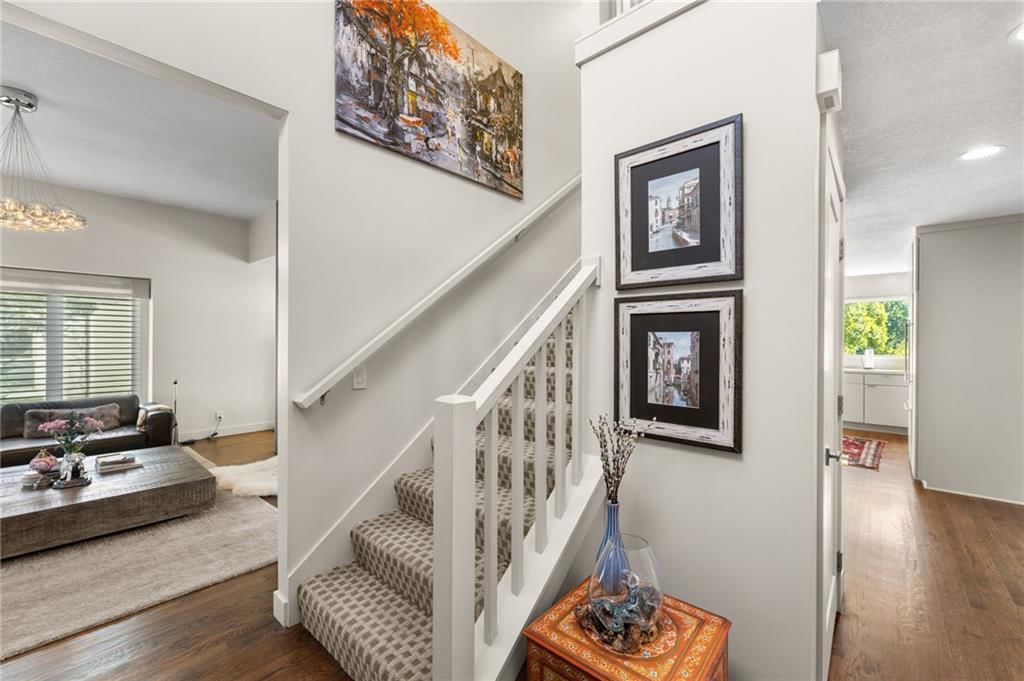 Hardwood floors, recessed lighting and staircase at 4503 NE Waters Edge Street, Lee's Summit, MO 64064