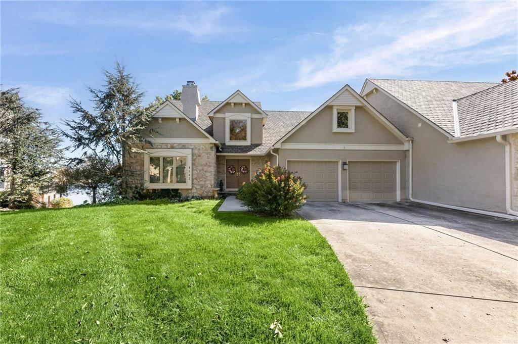 Traditional style, driveway and gray roof at 4503 NE Waters Edge Street, Lee's Summit, MO 64064