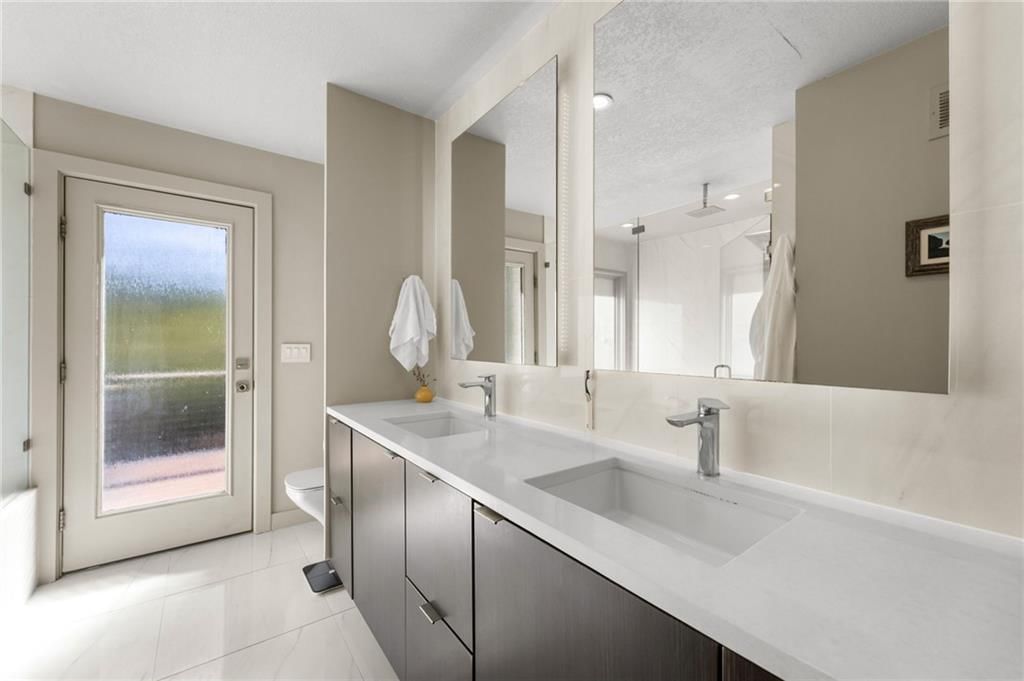 Double vanity and frameless glass shower at 4503 NE Waters Edge Street, Lee's Summit, MO 64064
