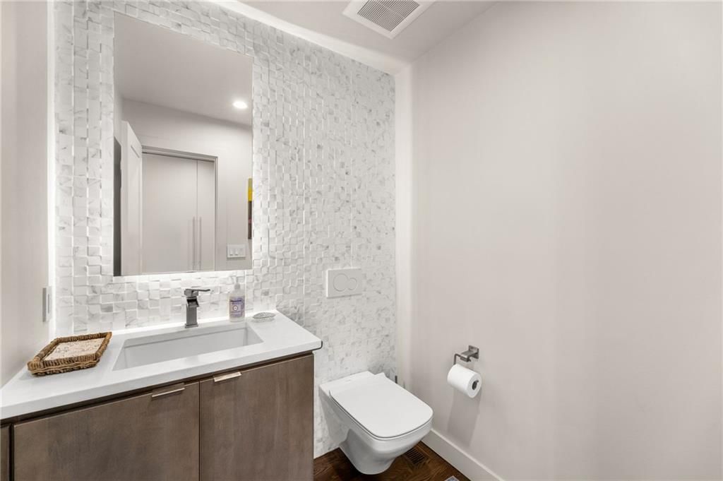 Tiled shower, wood vanity and renovated bathrooms at 4503 NE Waters Edge Street, Lee's Summit, MO 64064