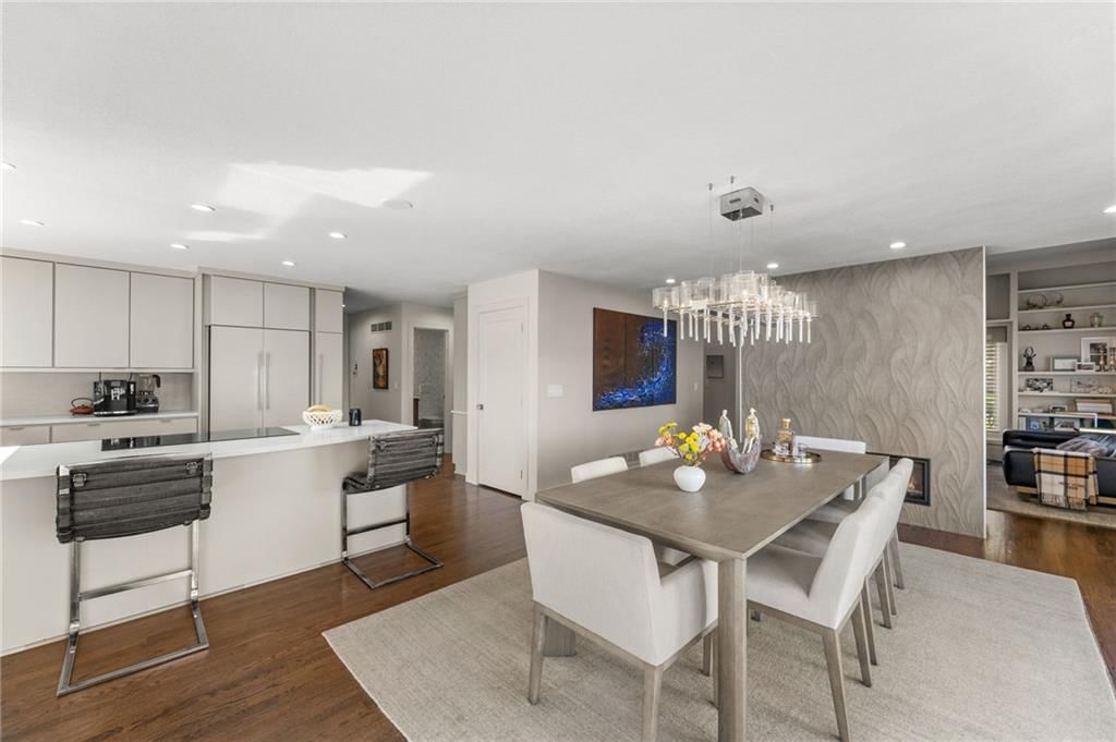 Kitchen island, white kitchen and quartz counters at 4503 NE Waters Edge Street, Lee's Summit, MO 64064