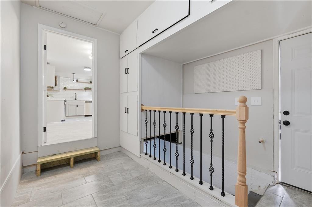 Tile floors, staircase and wood stair railing at 8503 Crystal Avenue, Kansas City, MO 66209