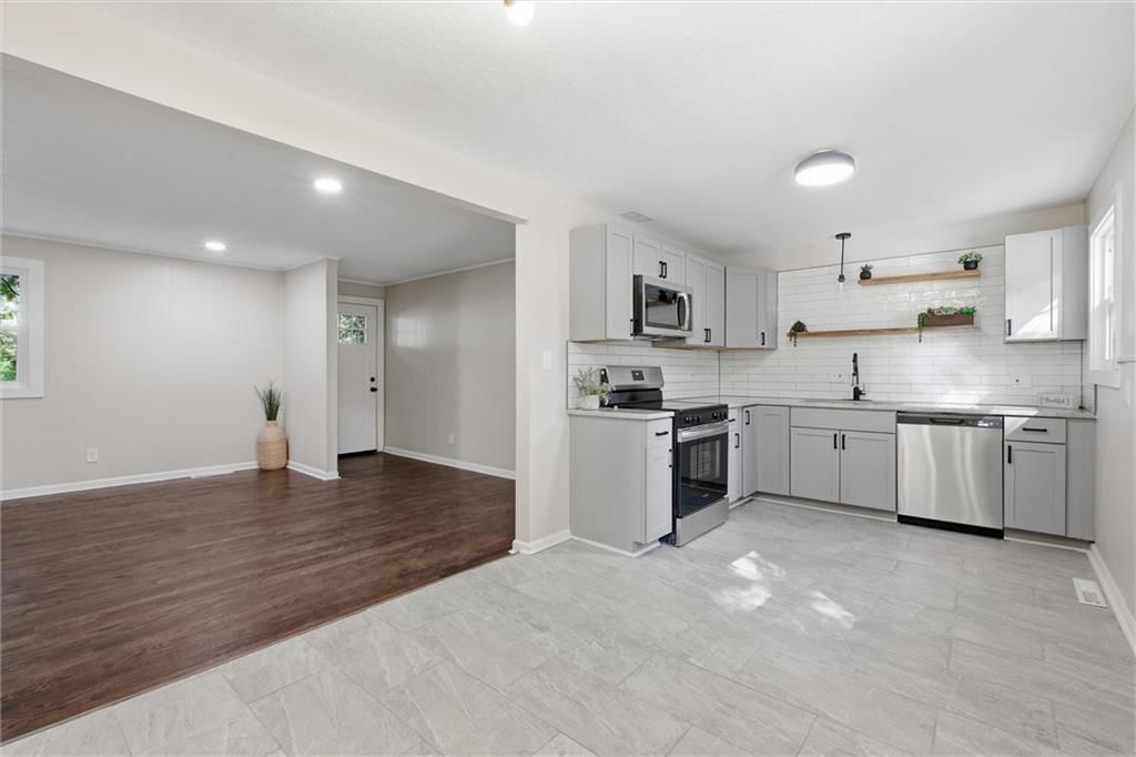 Open floor plan and statement lighting at 8503 Crystal Avenue, Kansas City, MO 66209