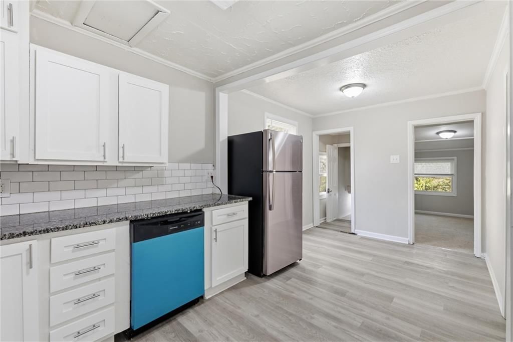 Open floor plan, white kitchen and granite counters at 10030 E 22ND Street, Independence, MO 64052