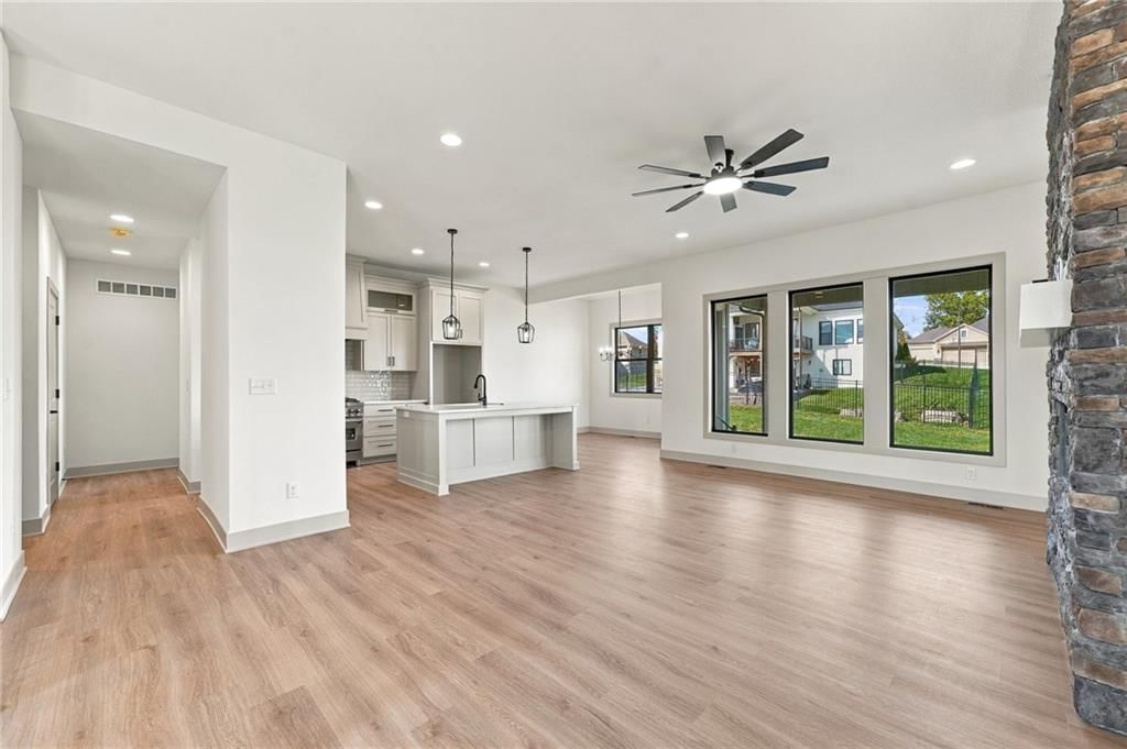 Open floor plan, kitchen island and wall of windows at 2605 NE Crestview Street, Blue Springs, MO 64029