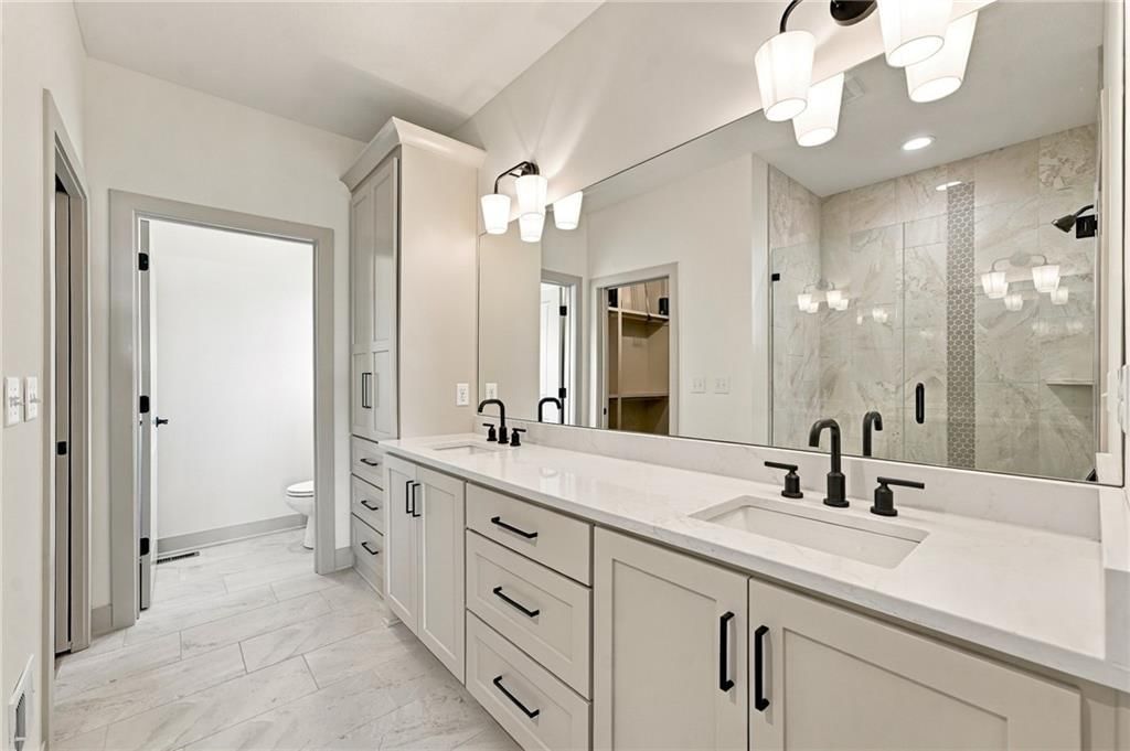 Private toilet room and double vanity at 2605 NE Crestview Street, Blue Springs, MO 64029