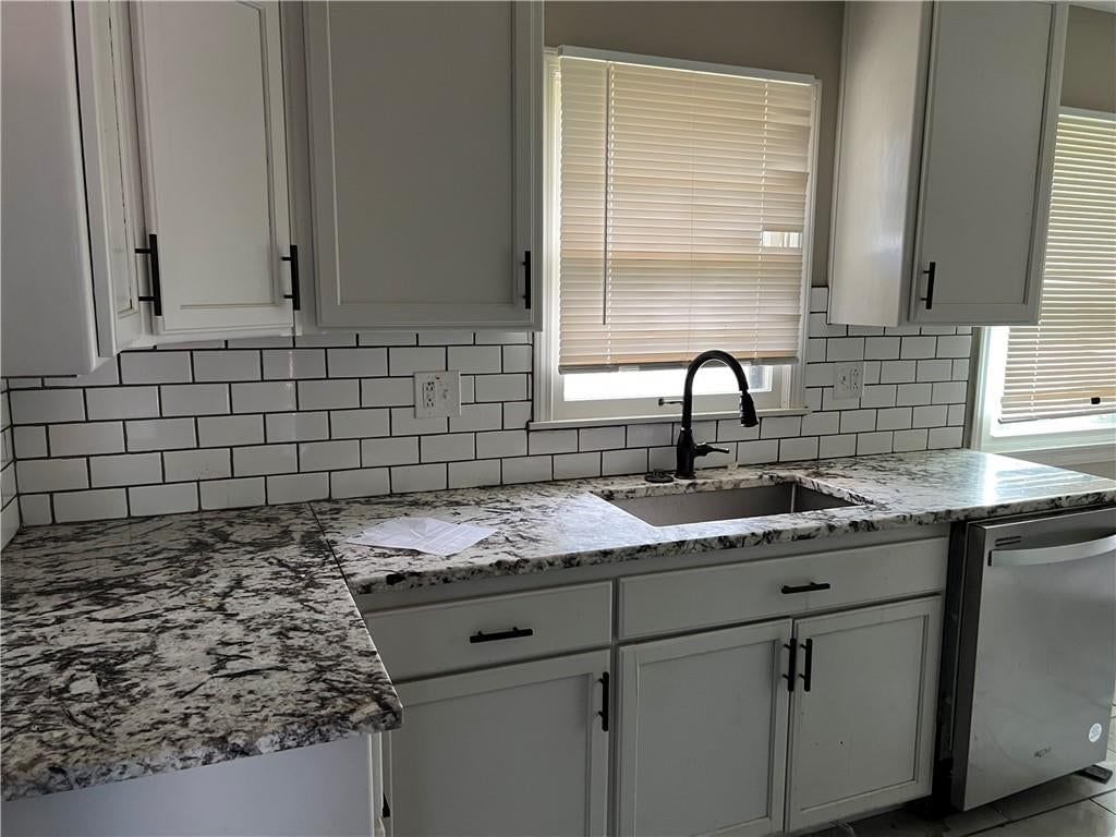 Granite counters and subway tile backsplash at 502 NW Central Street, Lee's Summit, MO 64063