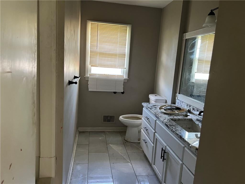 Tile floors, private toilet room and double vanity at 502 NW Central Street, Lee's Summit, MO 64063