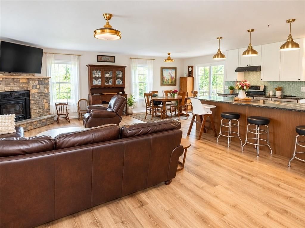 Open floor plan, kitchen island and statement lighting at 14090 Walker Road, Kansas City, MO 64163