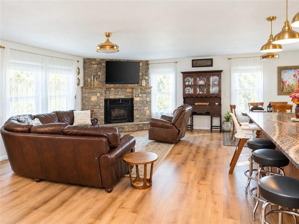 Fireplace, luxury vinyl floors and white trim at 14090 Walker Road, Kansas City, MO 64163