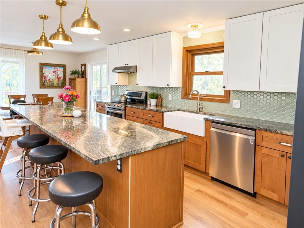 Granite counters, two-tone kitchen cabinets and shaker cabinets at 14090 Walker Road, Kansas City, MO 64163