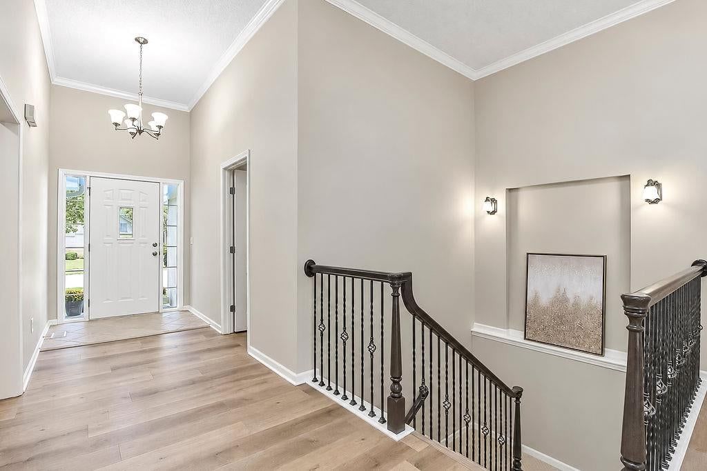Hardwood floors, staircase and iron stair railing at 9605 NE 100th Street, Kansas City, MO 64157