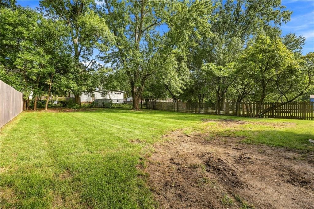 Big backyard, fenced yard and mature trees at 7907 Reinhardt Lane, Prairie Village, KS 66204