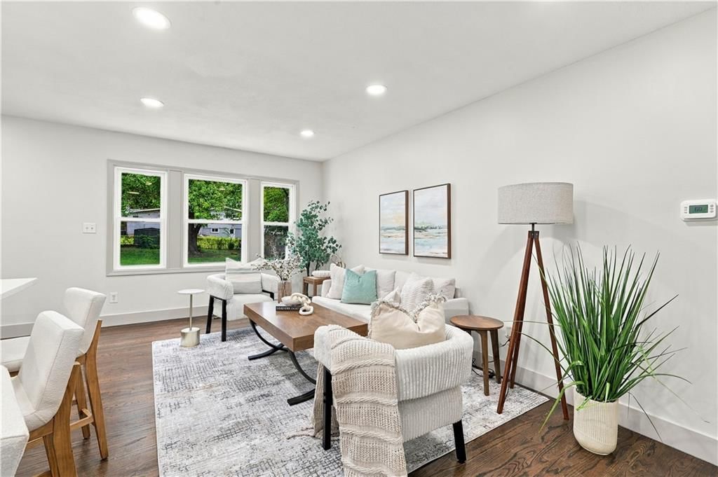 Hardwood floors, statement lighting and wall of windows at 7907 Reinhardt Lane, Prairie Village, KS 66204