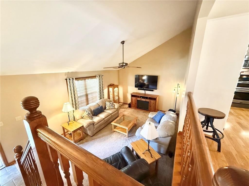 Open floor plan, staircase and wood stair railing at 2130 Sunset Circle, Pleasant Hill, MO 64080