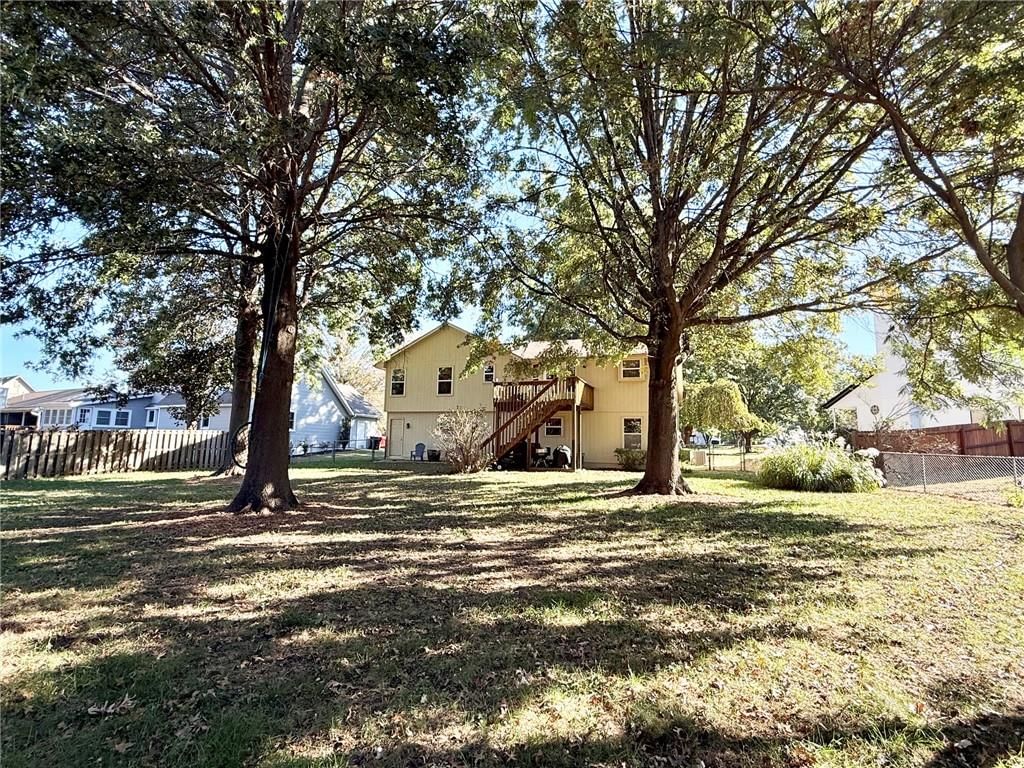 Deck, big backyard and fenced yard at 2130 Sunset Circle, Pleasant Hill, MO 64080