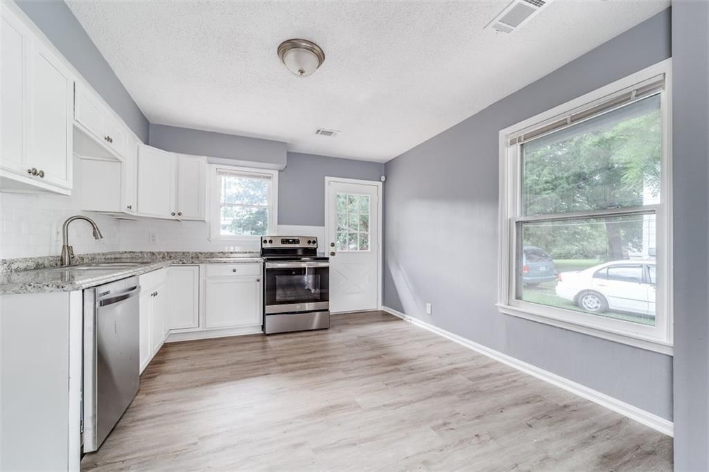 White kitchen, shaker cabinets and stainless steel appliances at 8234 Paseo Boulevard, Kansas City, MO 64131