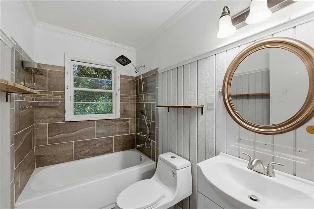 Shiplap / paneling and tiled shower at 2216 NE 39th Terrace, Kansas City, MO 64116