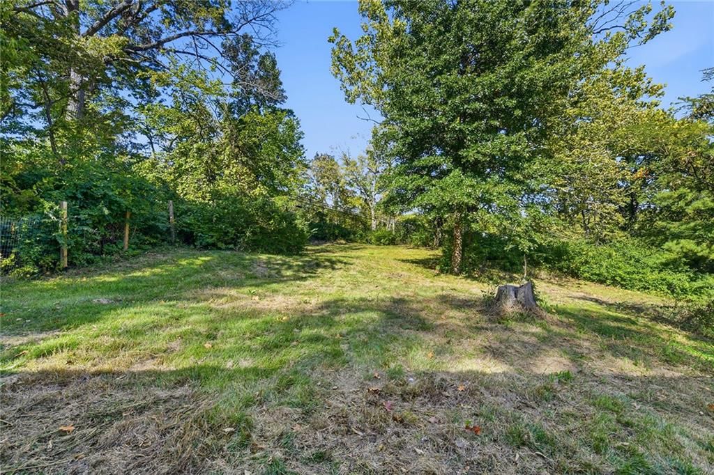 Big backyard, fenced yard and mature trees at 2216 NE 39th Terrace, Kansas City, MO 64116