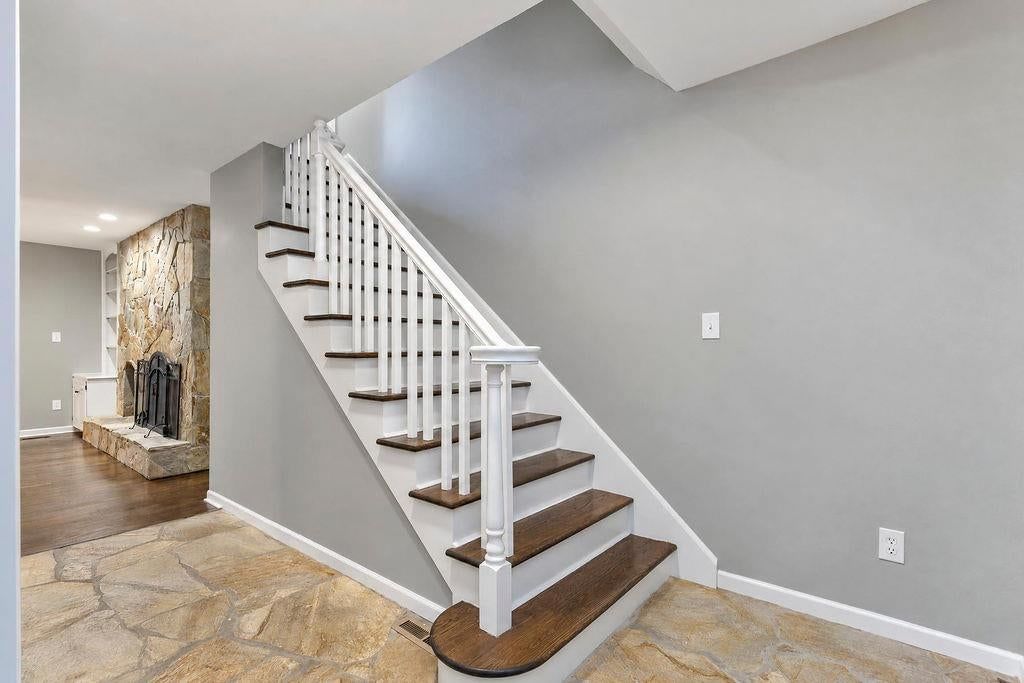 Staircase, wood stair railing and white trim at 13811 West 48th Street, Shawnee, KS 66217