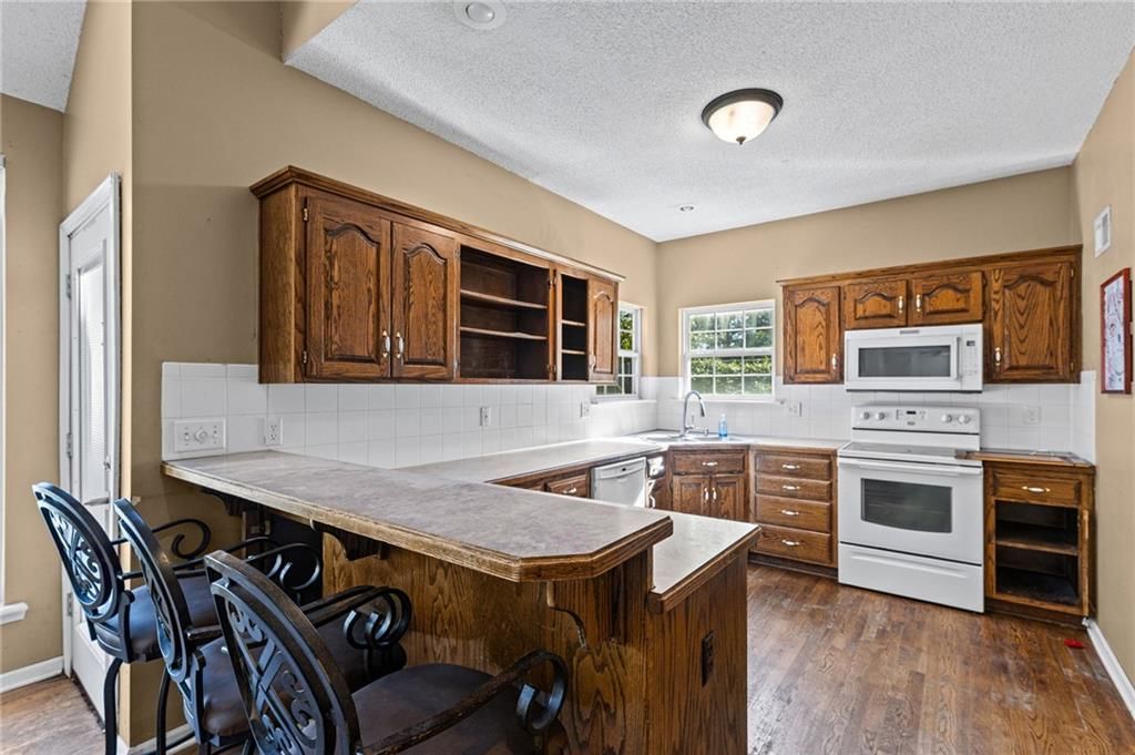 Kitchen island, quartz counters and wood kitchen cabinets at 18417 ELM Street, Gardner, KS 66030