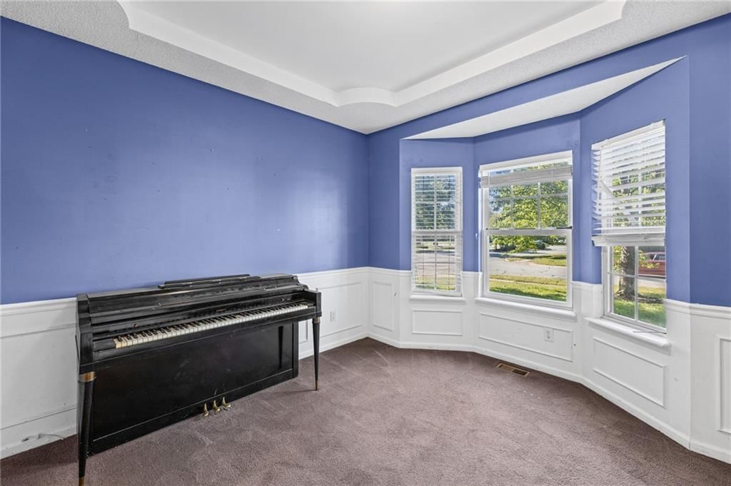 Wainscoting or board and batten, wall of windows and carpet at 18417 ELM Street, Gardner, KS 66030