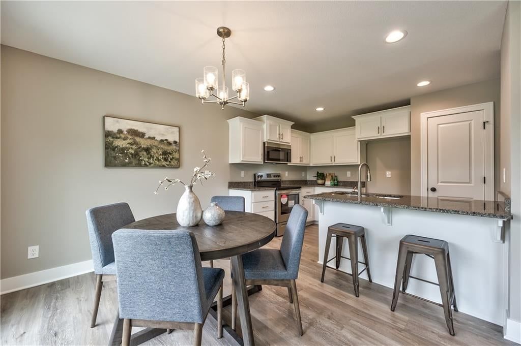 Kitchen island, white kitchen and granite counters at 304 N Franklin Street, Spring Hill, KS 66083