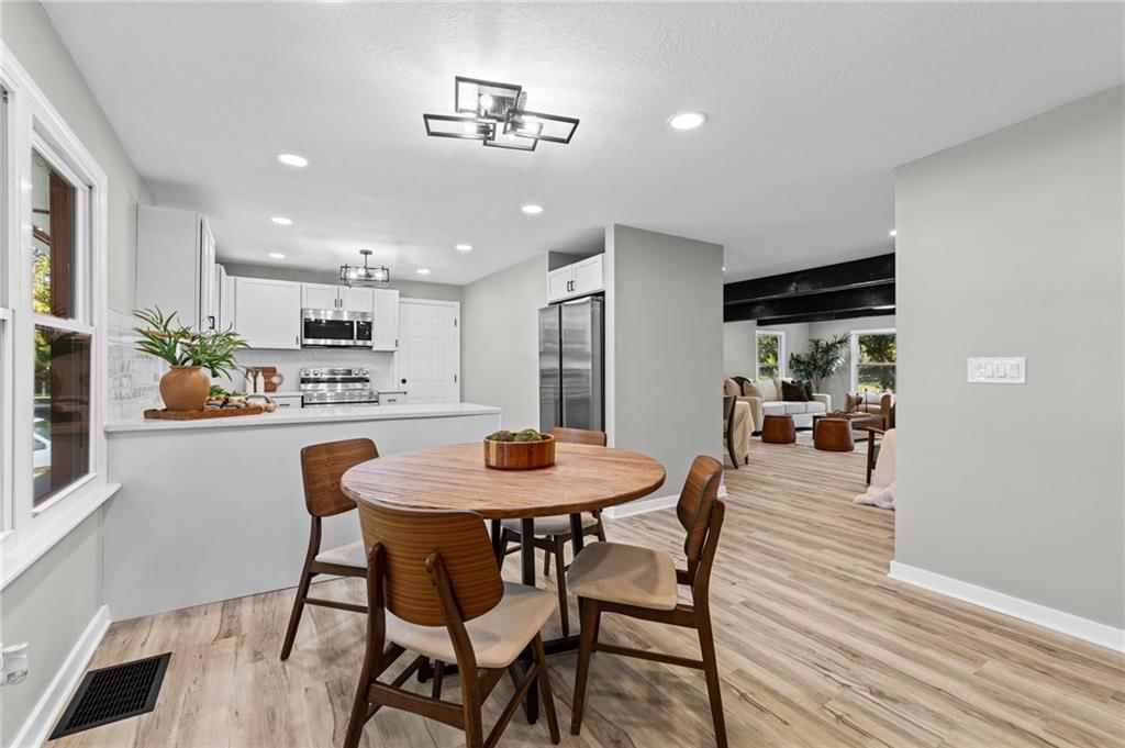 Open floor plan, white kitchen and statement lighting at 6601 W 79th Street, Overland Park, KS 66204