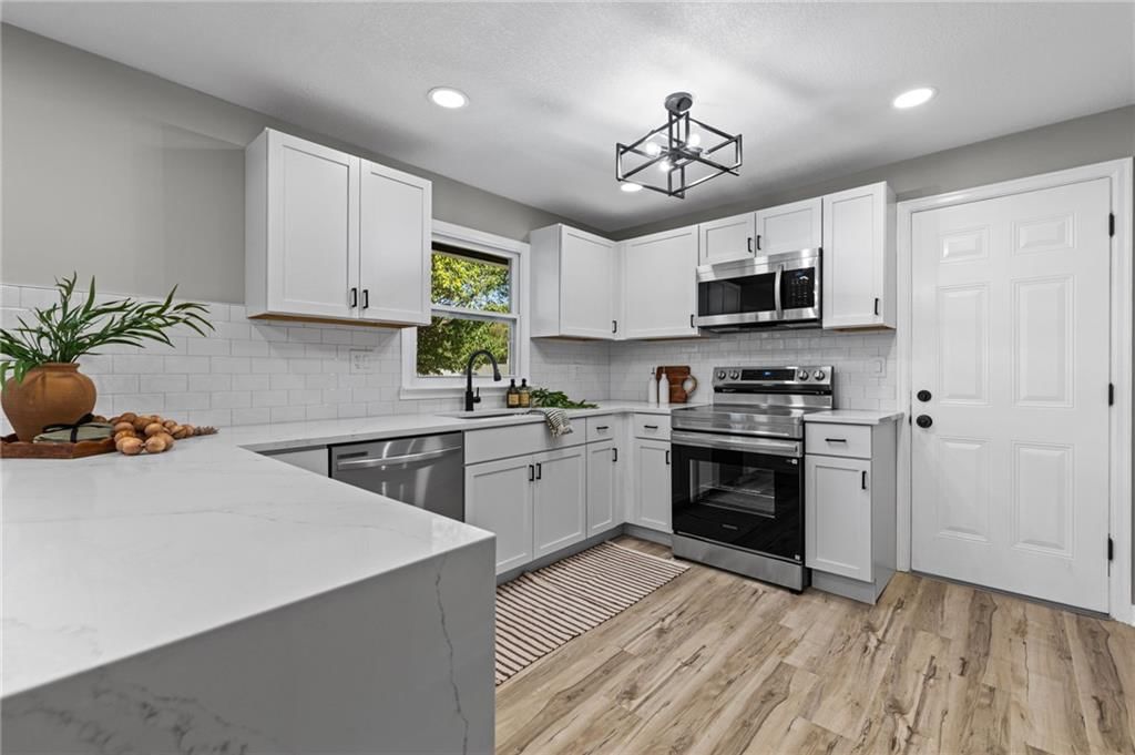 Shaker cabinets, stainless steel appliances and electric range at 6601 W 79th Street, Overland Park, KS 66204