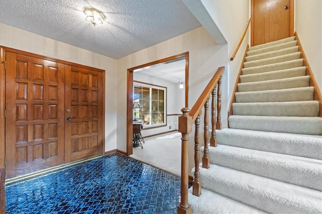 Staircase, wood stair railing and white trim at 204 NW Cypress Street, Lee's Summit, MO 64064