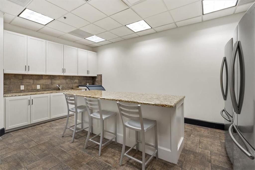 Kitchen island, white kitchen and granite counters at 1101 Walnut Street #609, Kansas City, MO 64106