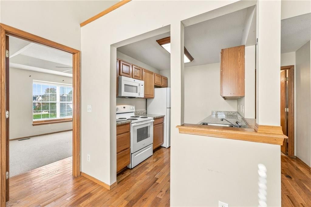 Updated kitchen, white appliances and kitchen backsplash at 200 SW Chartwell Drive, Lee's Summit, MO 64082