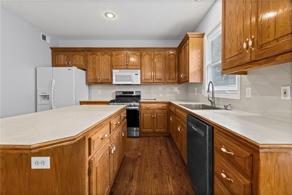 Kitchen island and kitchen backsplash at 8009 W 144th Place, Overland Park, KS 66223