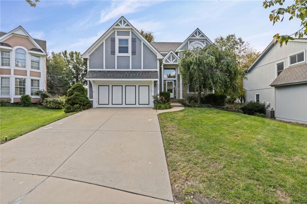 Attached garage and concrete driveway at 8009 W 144th Place, Overland Park, KS 66223