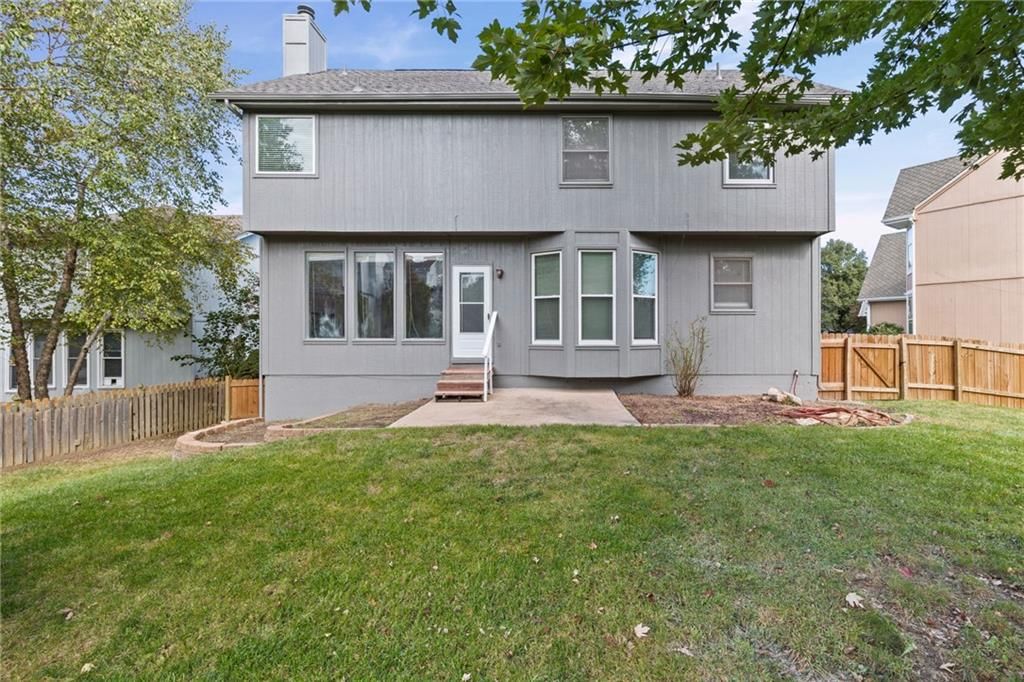Fenced yard, concrete patio and flat lot at 8009 W 144th Place, Overland Park, KS 66223