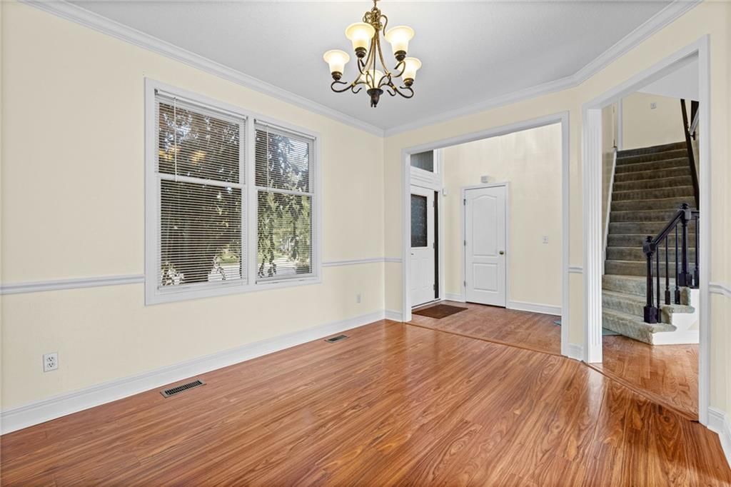Statement lighting, wainscoting or board and batten and staircase at 8009 W 144th Place, Overland Park, KS 66223