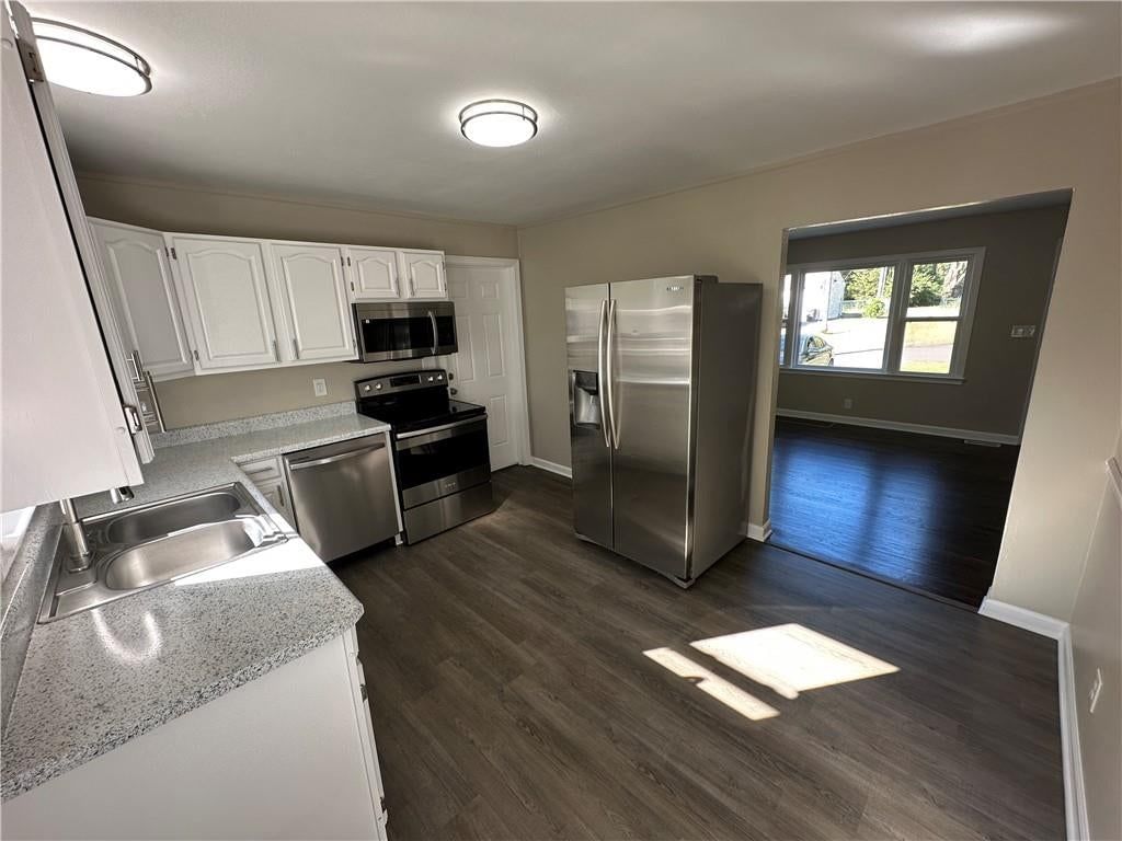 Kitchen open to the living area at 11113 E 25th Street, Independence, MO 64052