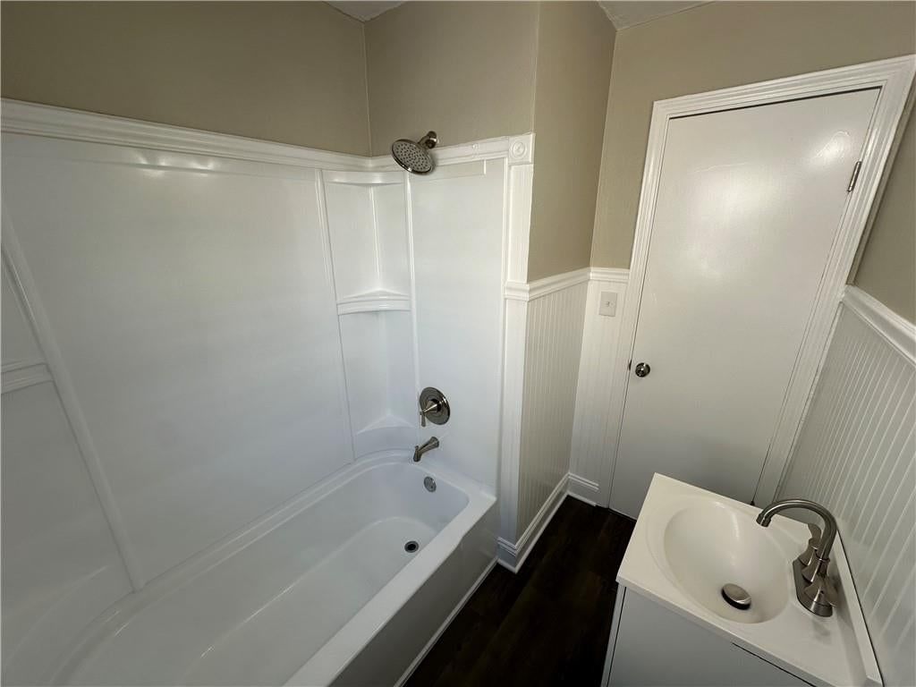 Tiled shower, white vanity and tub and shower combo at 11113 E 25th Street, Independence, MO 64052