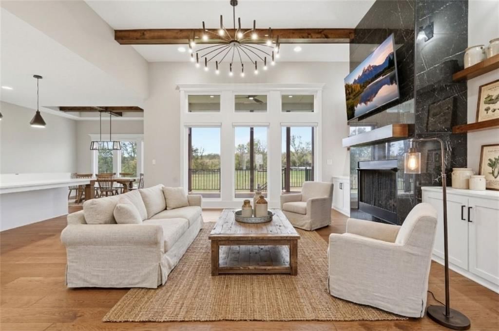 Tall ceilings, open floor plan and floor-to-ceiling windows at 1 S Buffalo Ridge Court, Lake Winnebago, MO 64034