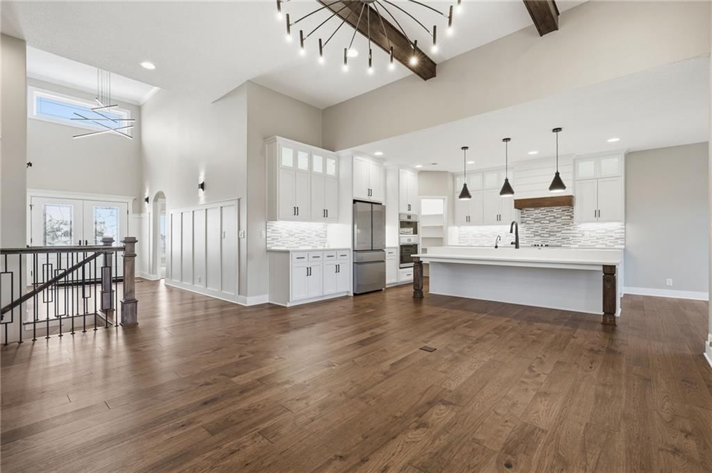 Kitchen island, white kitchen and quartz counters at 1 S Buffalo Ridge Court, Lake Winnebago, MO 64034