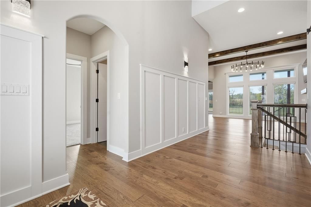 Hardwood floors, staircase and iron stair railing at 1 S Buffalo Ridge Court, Lake Winnebago, MO 64034