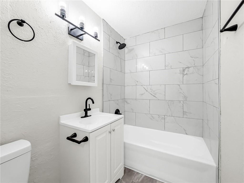 Tiled shower and renovated bathrooms at 2221 N 36th Street, Kansas City, KS 66104