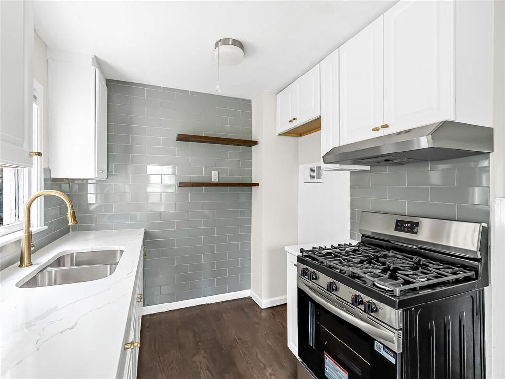 Gas range and black appliances at 2221 N 36th Street, Kansas City, KS 66104
