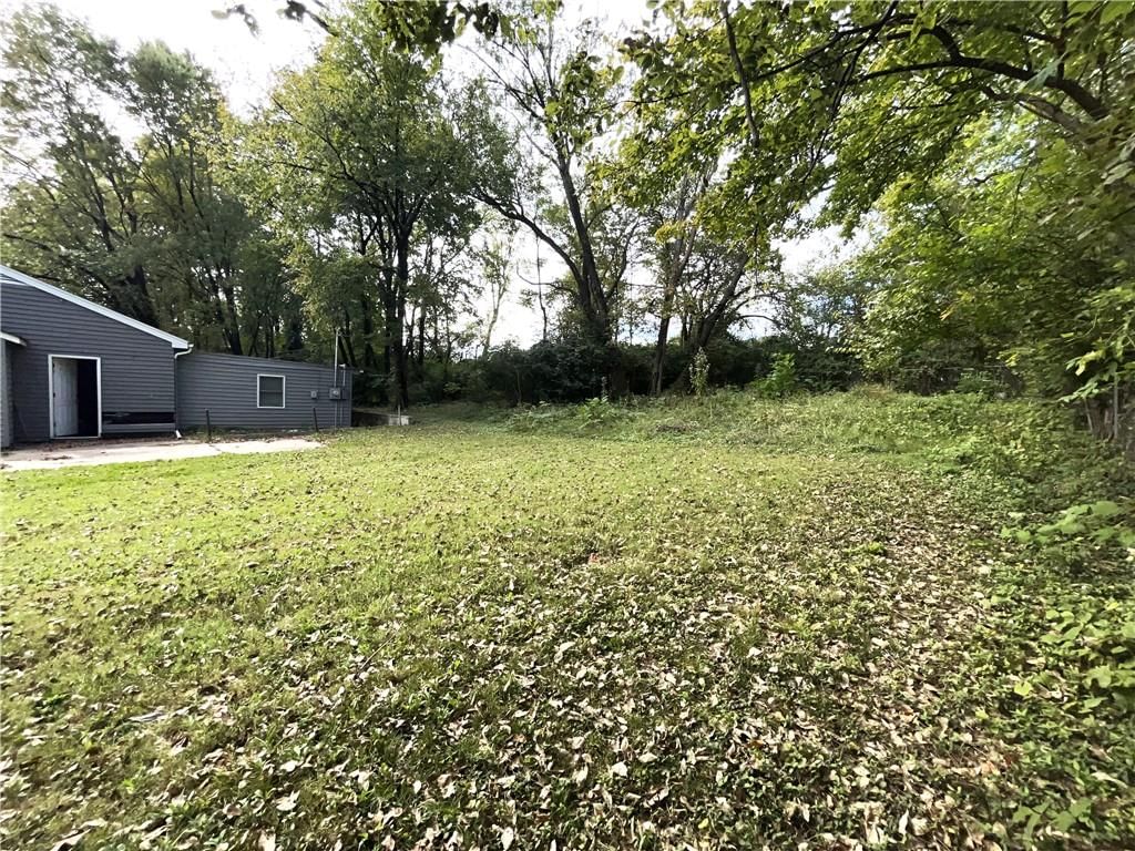 Big backyard, mature trees and concrete patio at 7416 Montgall Avenue, Kansas City, MO 64132