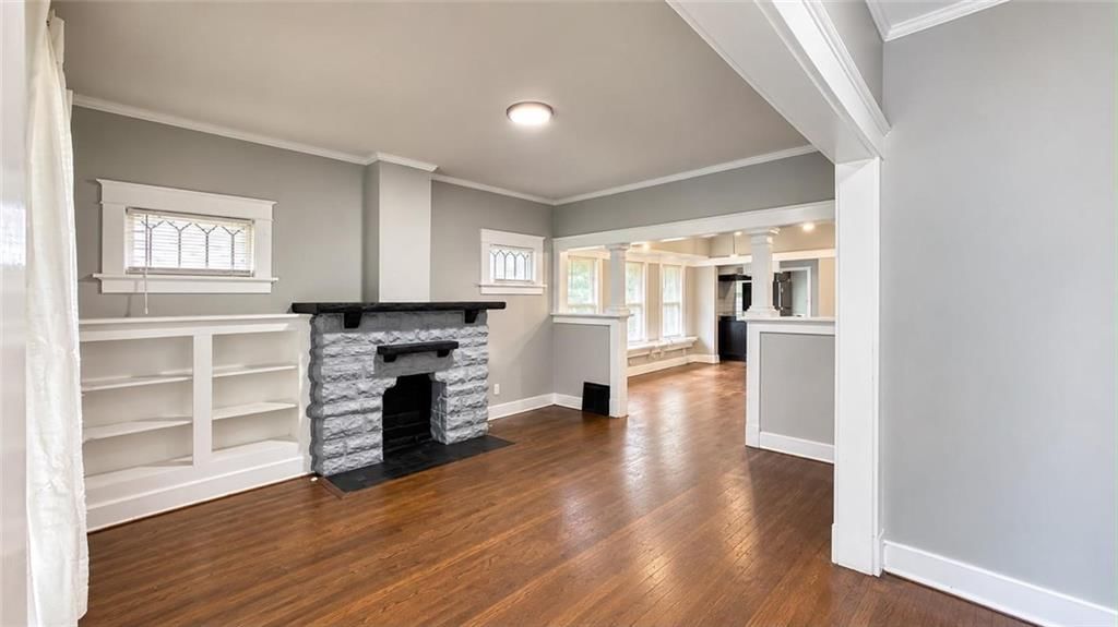 Fireplace, open floor plan and hardwood floors at 3942 Flora Avenue, Kansas City, MO 64110