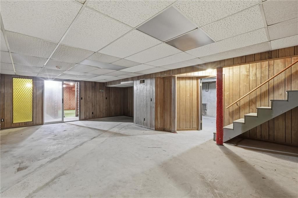 Finished basement, staircase and wood stair railing at 9209 W 47th Street, Merriam, KS 66203