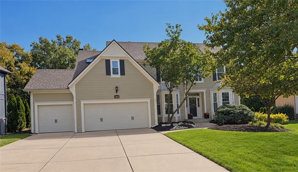 Garage for three or more cars, covered front porch and traditional style at 12824 GRANT Street, Overland Park, KS 66213