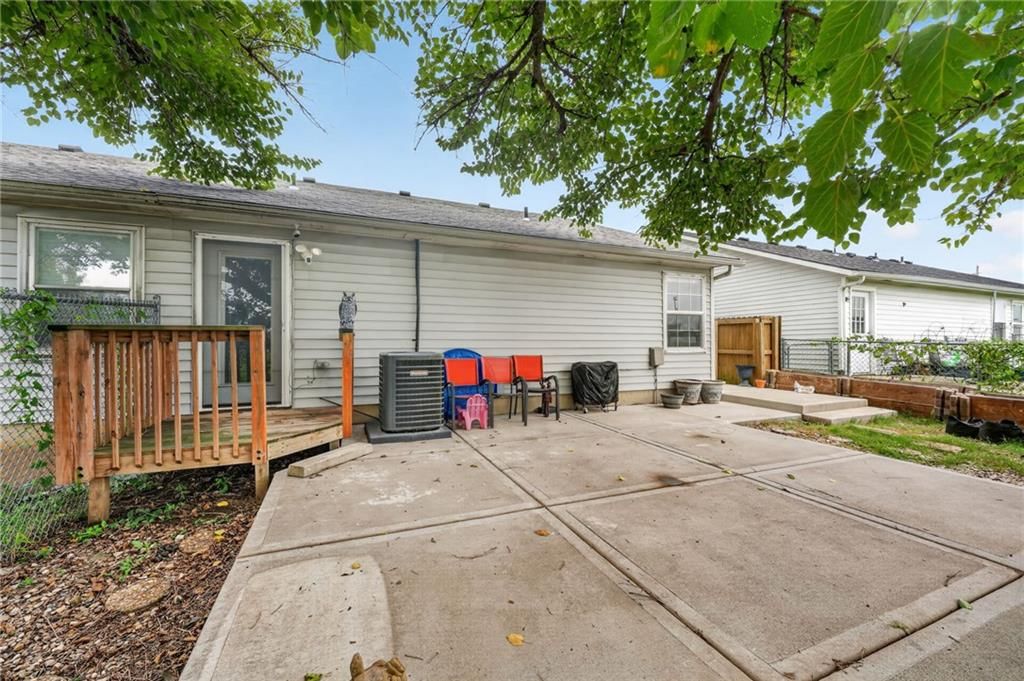 Fenced yard, mature trees and wood fence at 123 E Madison Street, Gardner, KS 66030